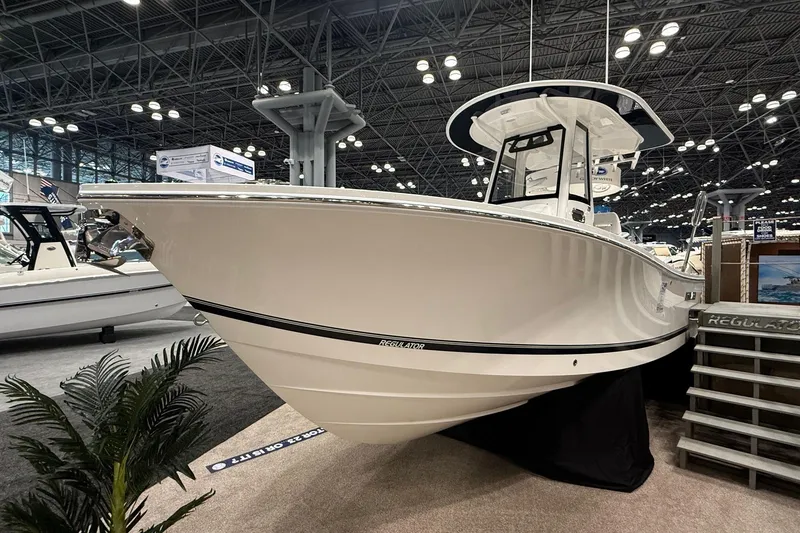 Slide: The Image of 2026 Regulator 23 boat displayed at an indoor exhibition, showcasing sleek design and modern features. - 4
