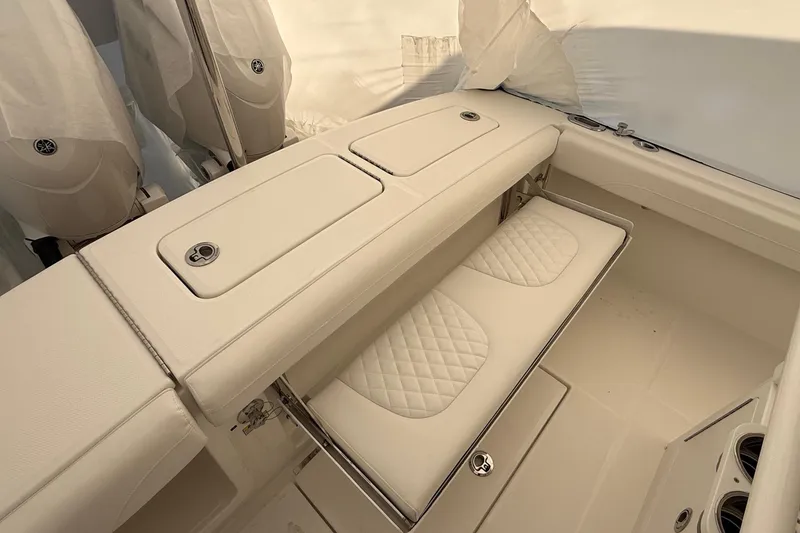 Slide: The Image of 2026 Regulator 23 boat interior with cushioned seating and storage compartments. - 40