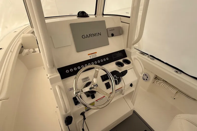 Slide: The Image of 2026 Regulator 23 boat helm with Garmin navigation system and steering wheel. - 41