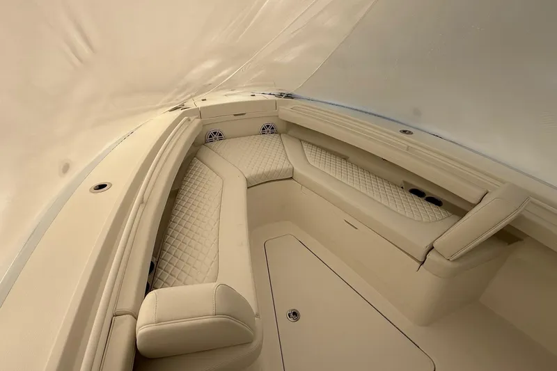 Slide: The Image of 2026 Regulator 23 boat interior with beige cushioned seating and elegant design. - 44