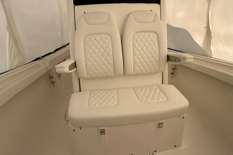 Slide: The Image of 2026 Regulator 23 boat interior with white cushioned seating and diamond stitching. - 45