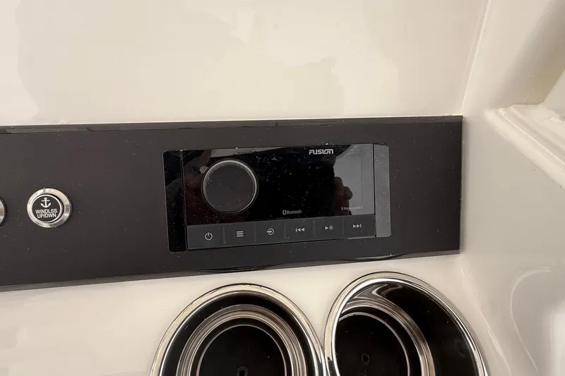 Slide: The Image of Control panel of a 2026 Regulator 23 boat featuring a Fusion audio system. - 52