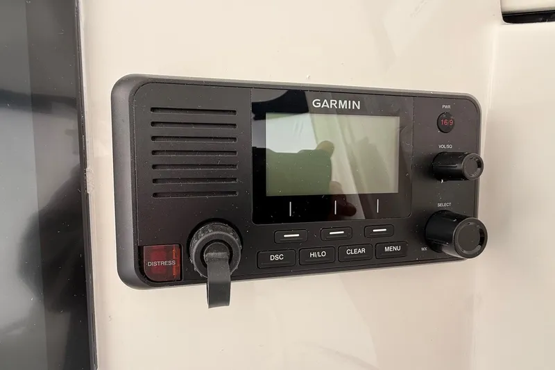Slide: The Image of Garmin marine radio on 2026 Regulator 23 boat dashboard, featuring distress button. - 53