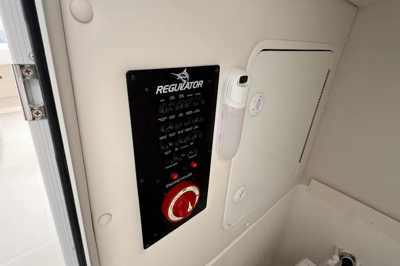 Slide: The Image of Control panel of 2026 Regulator 23 boat, featuring switches and engine controls. - 59