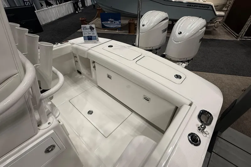 Slide: The Image of 2026 Regulator 23 boat interior with dual Yamaha engines at a boat show. - 6