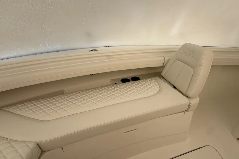 Slide: The Image of Luxurious seating on 2026 Regulator 23 boat with quilted upholstery and cup holders. - 62