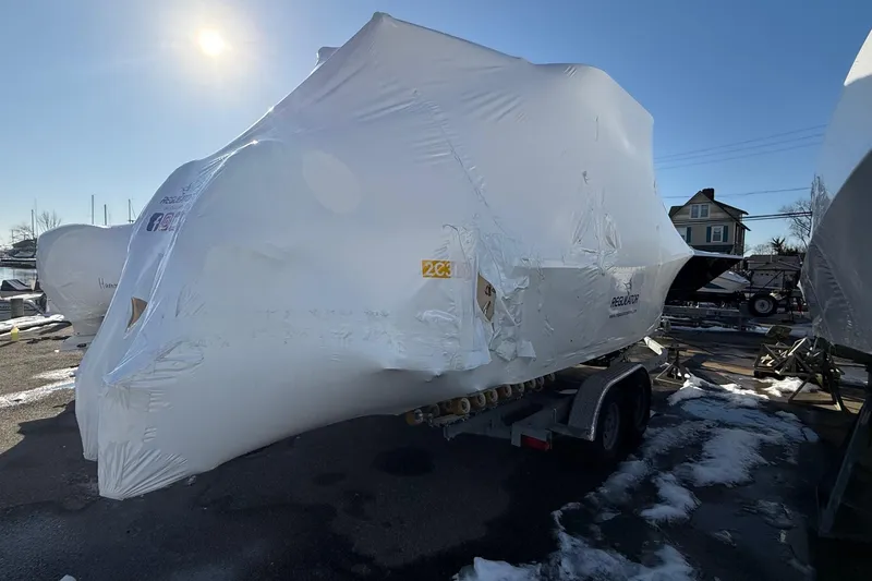 Slide: The Image of Covered 2026 Regulator 23 boat on trailer in snowy outdoor setting. - 63
