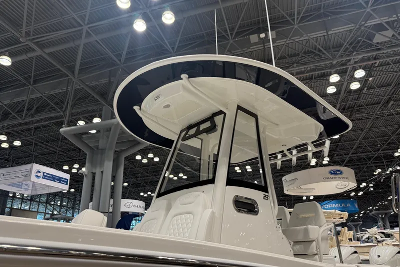 Slide: The Image of 2026 Regulator 23 boat displayed at an indoor exhibition, showcasing sleek design and modern features. - 8