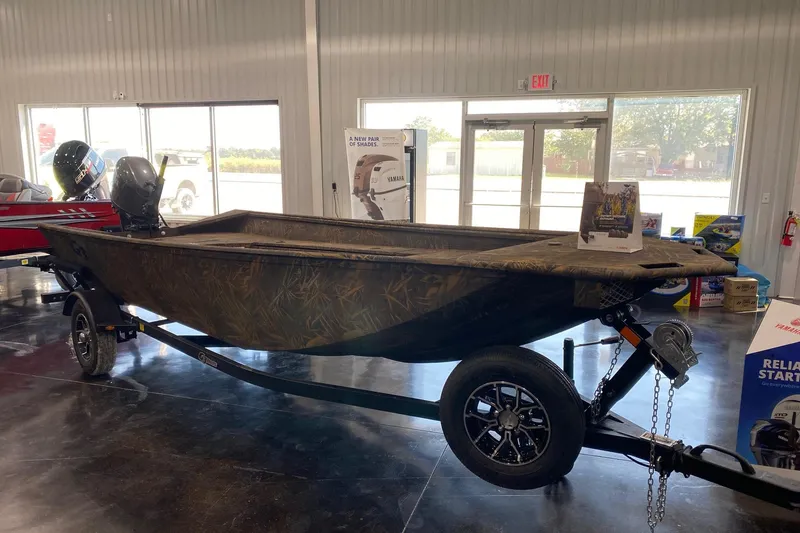 Slide: The Image of 2026 G3 Gator Tough 17 DK boat displayed indoors on a trailer. - 4