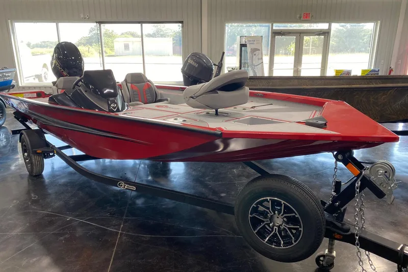 The Image of 2026 G3 Sportsman 1710 SE boat, red, displayed indoors on a trailer. - 0