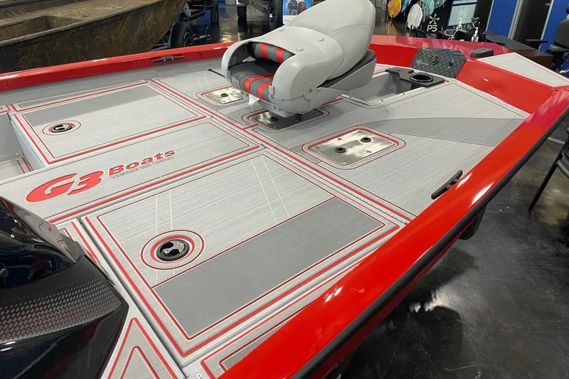 Slide: The Image of 2026 G3 Sportsman 1710 SE boat deck with red accents and seating. - 8