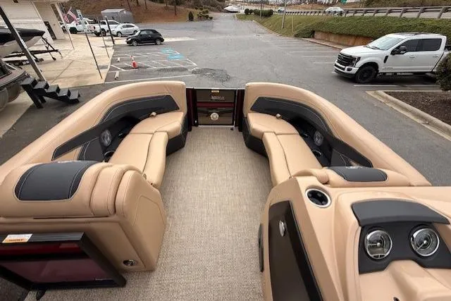 Slide: The Image of 2026 Barletta C22QC pontoon boat interior with beige seating and dashboard. - 10