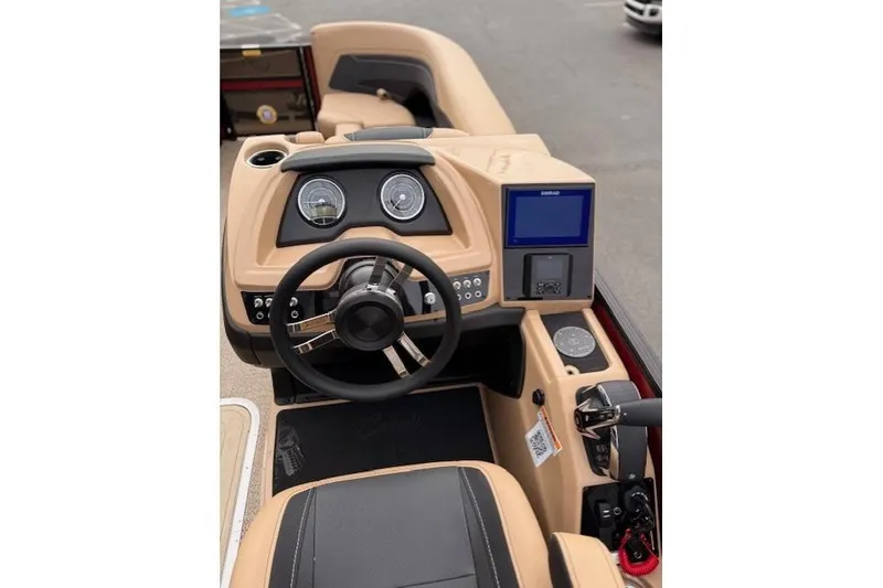 Slide: The Image of 2026 Barletta C22QC boat dashboard with steering wheel and digital display. - 9