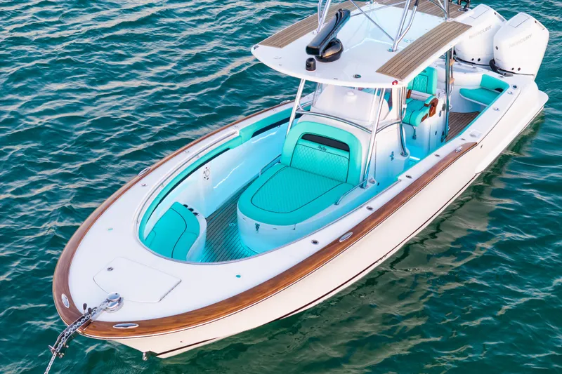 Slide: The Image of 2019 Mag Bay 33 CC boat with turquoise seating on calm water. - 14