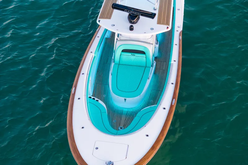 Slide: The Image of 2019 Mag Bay 33 CC boat with turquoise seating, viewed from above on water. - 15