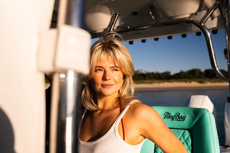 Slide: The Image of Woman enjoying a sunny day on a 2019 Mag Bay 33 CC boat. - 29