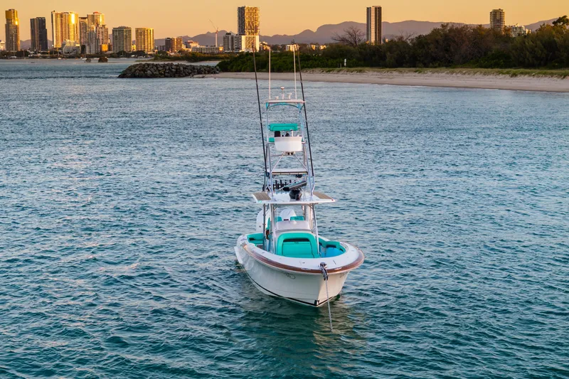 Slide: The Image of 2019 Mag Bay 33 CC boat on water with city skyline in background. - 3