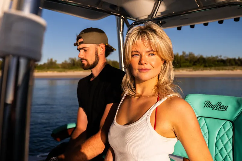Slide: The Image of Couple enjoying a sunny day on a 2019 Mag Bay 33 CC boat. - 30