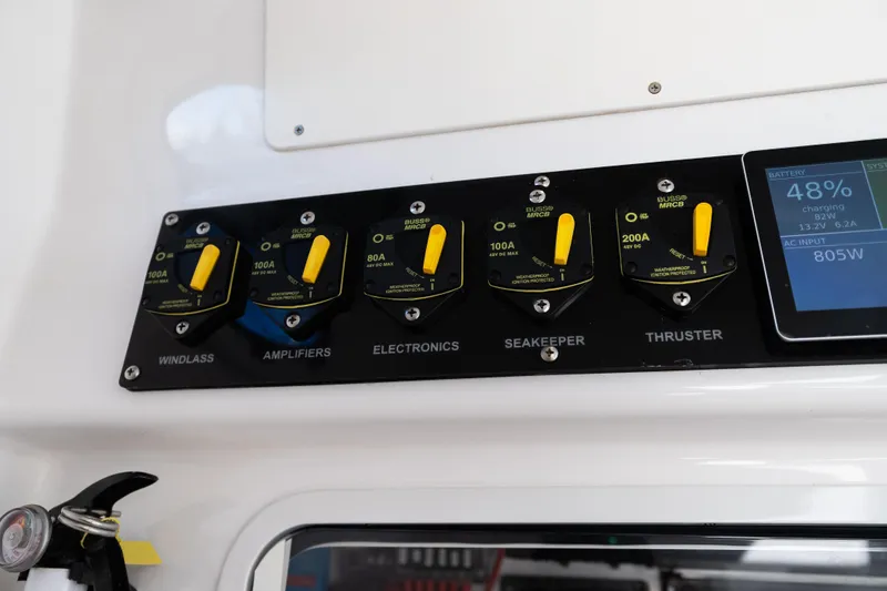 Slide: The Image of Control panel of a 2019 Mag Bay 33 CC boat with battery status display. - 33