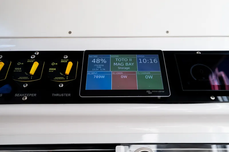 Slide: The Image of Control panel of a 2019 Mag Bay 33 CC boat displaying battery and system status. - 34