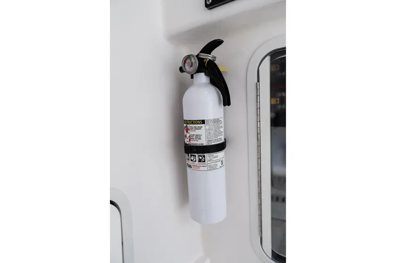 Slide: The Image of Fire extinguisher mounted on 2019 Mag Bay 33 CC boat interior. - 36