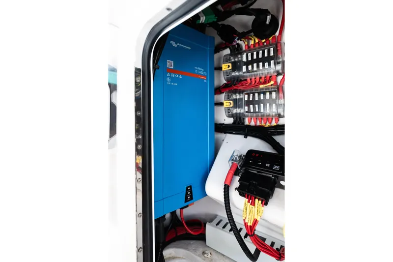 Slide: The Image of Electrical system inside 2019 Mag Bay 33 CC boat, featuring blue power inverter. - 37