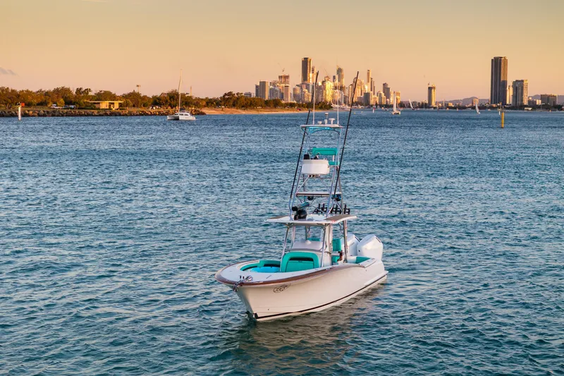 Slide: The Image of 2019 Mag Bay 33 CC boat on water with city skyline in background. - 4