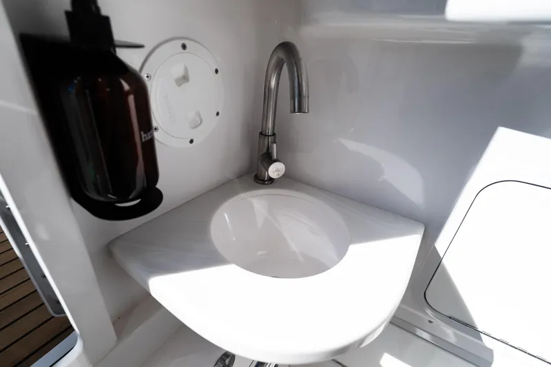Slide: The Image of 2019 Mag Bay 33 CC boat interior sink with faucet and soap dispenser. - 47