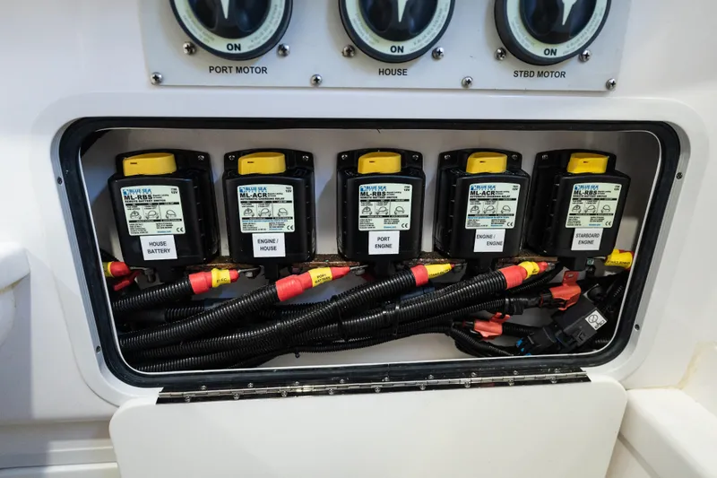 Slide: The Image of Electrical panel of 2019 Mag Bay 33 CC boat with labeled switches and wiring. - 57