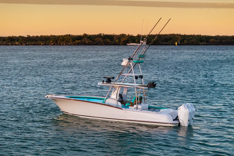 Slide: The Image of 2019 Mag Bay 33 CC boat on calm water at sunset. - 6
