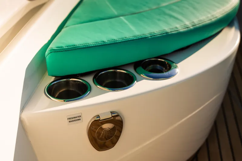 Slide: The Image of 2019 Mag Bay 33 CC boat with green cushion and cup holders. - 61