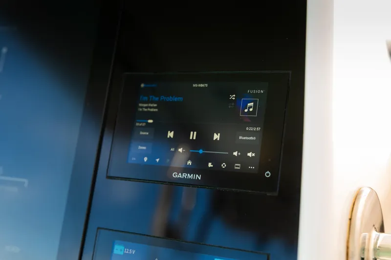 Slide: The Image of Garmin display on 2019 Mag Bay 33 CC boat showing music controls. - 65