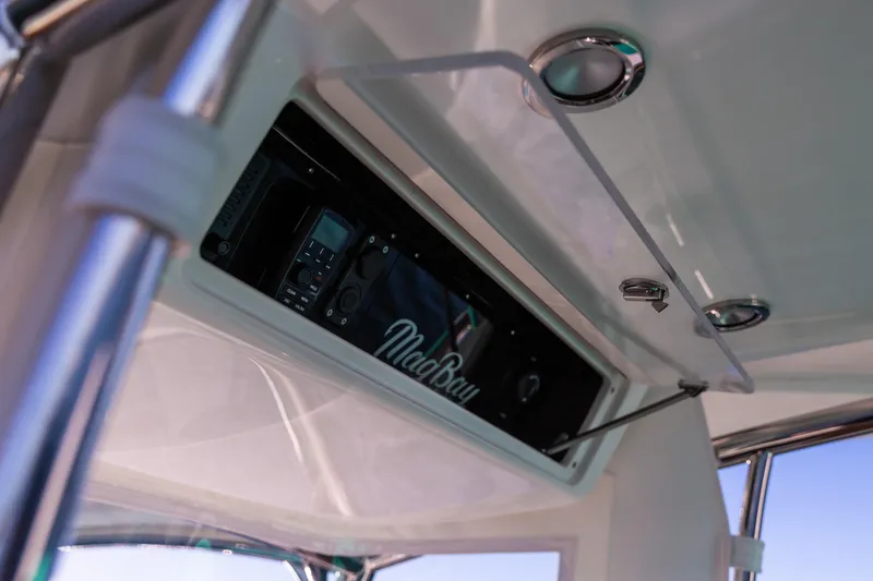 Slide: The Image of 2019 Mag Bay 33 CC boat console with electronics and storage compartment. - 67