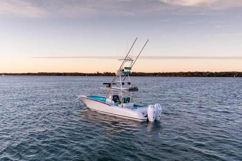 Slide: The Image of 2019 Mag Bay 33 CC boat on calm water at sunset. - 7