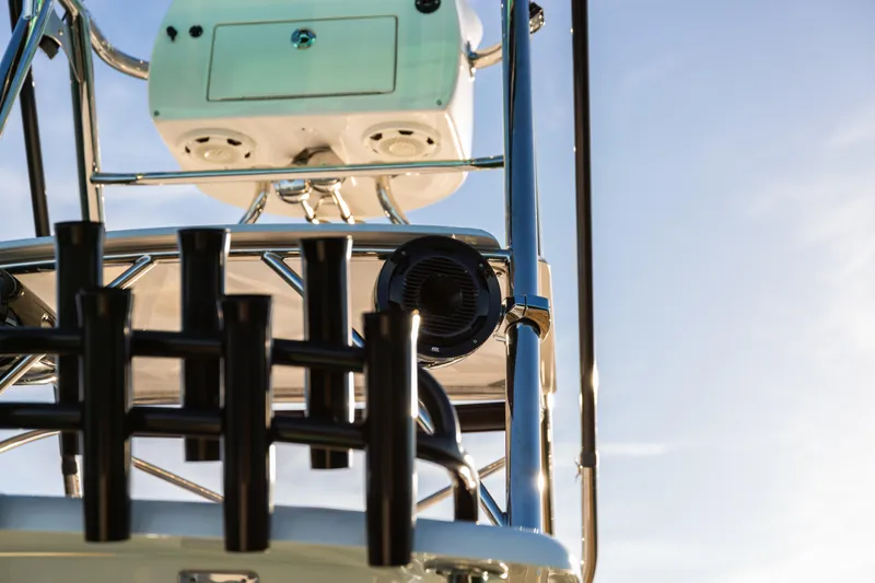 Slide: The Image of 2019 Mag Bay 33 CC boat tower with rod holders and speakers against blue sky. - 72