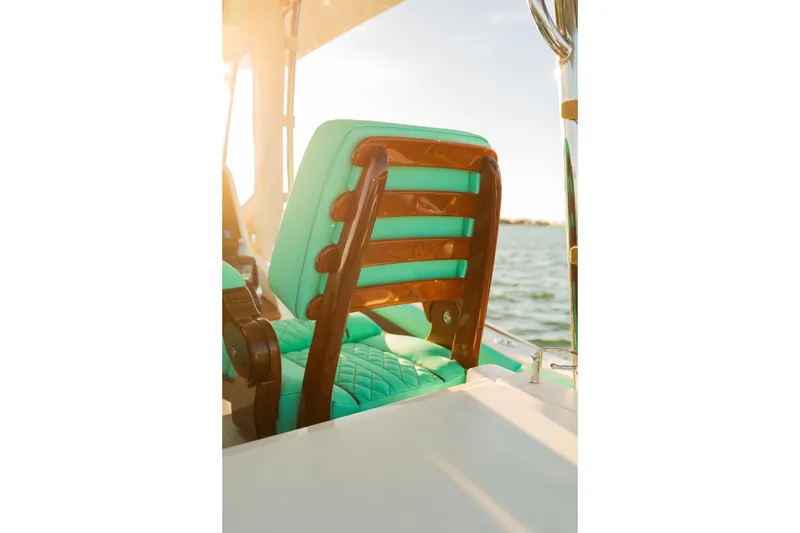 Slide: The Image of Luxurious seating on 2019 Mag Bay 33 CC boat with turquoise cushions and wooden accents. - 75