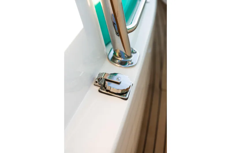 Slide: The Image of 2019 Mag Bay 33 CC boat detail with stainless steel hardware and wooden deck. - 78