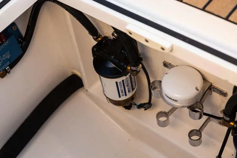 Slide: The Image of 2019 Mag Bay 33 CC boat engine compartment with Simrad equipment and fuel filter. - 81