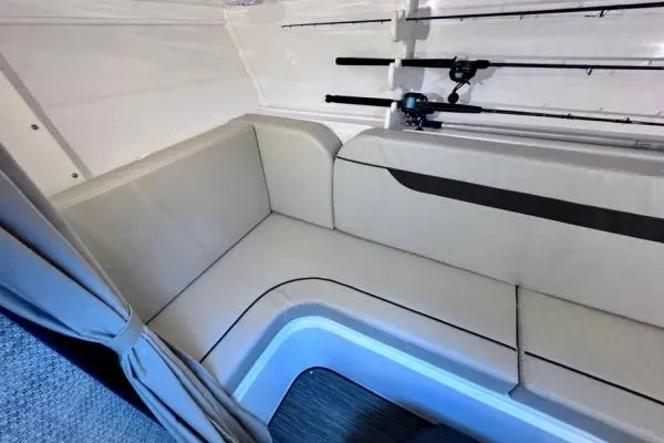 Slide: The Image of 2022 Stamas 370 Aegean interior with beige seating and fishing rods. - 12