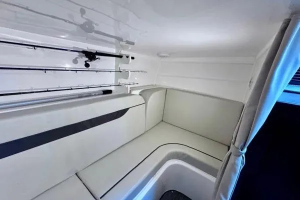 Slide: The Image of 2022 Stamas 370 Aegean cabin interior with seating and fishing rod storage. - 13