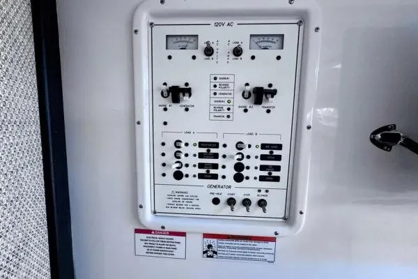 Slide: The Image of Electrical control panel on 2022 Stamas 370 Aegean boat, featuring switches and gauges. - 26