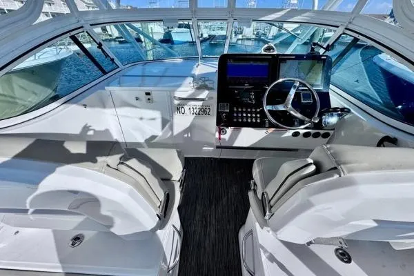 Slide: The Image of 2022 Stamas 370 Aegean boat cockpit with modern controls and seating, docked at marina. - 35