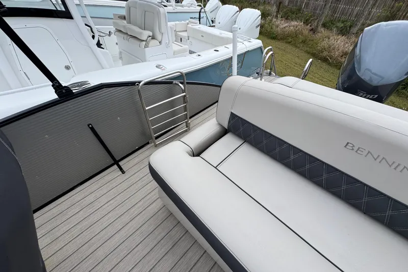 Slide: The Image of 2019 Bennington 25 RSBDN boat interior with seating and ladder, showcasing luxury design. - 28