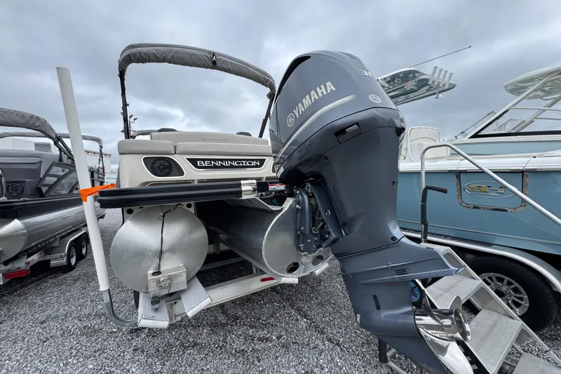 Slide: The Image of 2019 Bennington 25 RSBDN pontoon boat with Yamaha outboard motor, displayed outdoors. - 8
