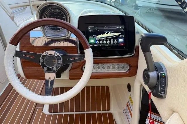 Slide: The Image of 2022 Chris-Craft Launch 25 GT dashboard with steering wheel and digital display. - 11