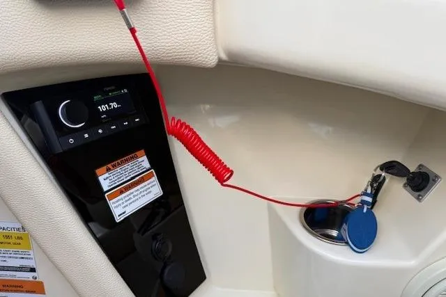 Slide: The Image of 2022 Chris-Craft Launch 25 GT dashboard with radio and safety features. - 12