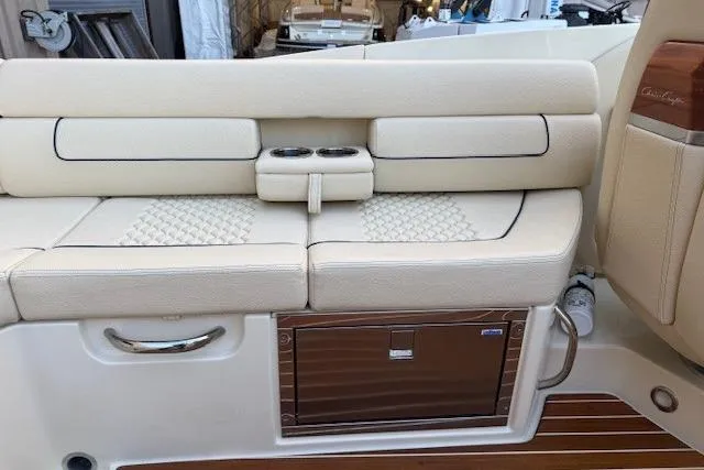 Slide: The Image of 2022 Chris-Craft Launch 25 GT boat interior with beige seating and wooden accents. - 13