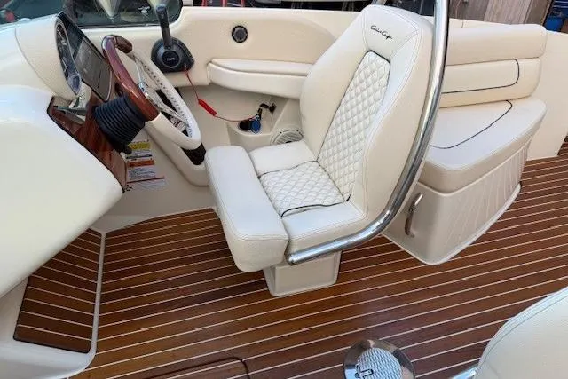 Slide: The Image of 2022 Chris-Craft Launch 25 GT interior with luxurious seating and elegant wood flooring. - 16