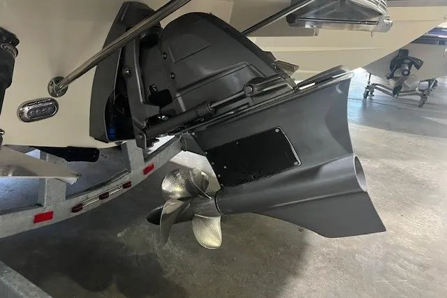 Slide: The Image of 2022 Chris-Craft Launch 25 GT boat propeller and stern detail in a showroom. - 23