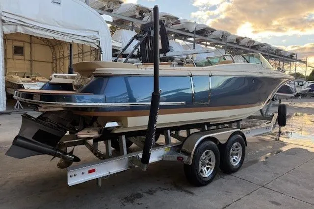 Slide: The Image of 2022 Chris-Craft Launch 25 GT boat on trailer in marina setting. - 3
